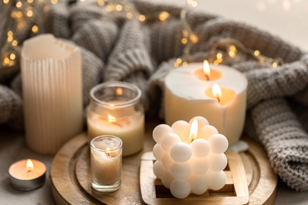 cozy-composition-with-candles-knitted-element-garland.jpg
